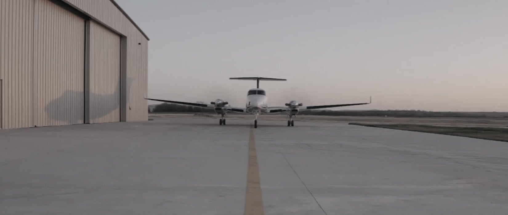 plane next to a hangar